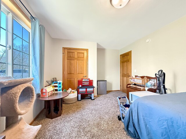 bedroom featuring carpet floors and baseboards