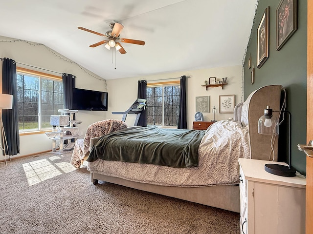 carpeted bedroom with lofted ceiling, multiple windows, a ceiling fan, and baseboards