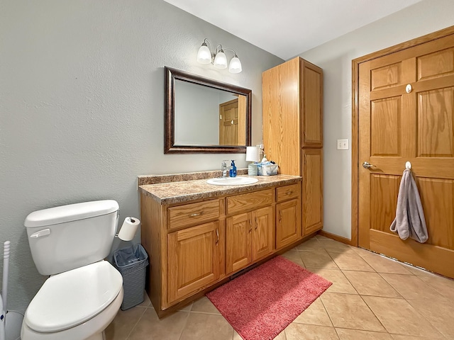 bathroom with tile patterned floors, toilet, and vanity