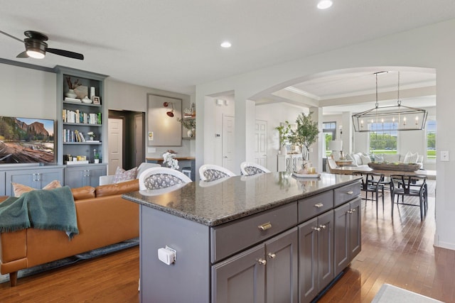 343 Primrose Path, Bayport, MN 55003 - kitchen with open floor plan, arched walkways, gray cabinets, crown molding, and dark wood-type flooring
