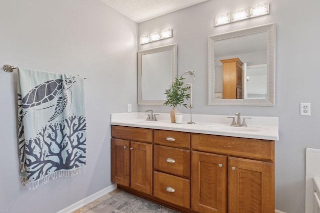 343 Primrose Path, Bayport, MN 55003 - bathroom featuring a textured ceiling, double vanity, and baseboards