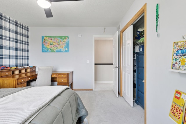343 Primrose Path, Bayport, MN 55003 - bedroom featuring light colored carpet, a closet, baseboards, ceiling fan, and a textured ceiling