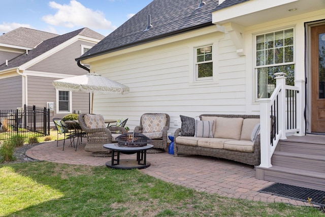 343 Primrose Path, Bayport, MN 55003 - back of property with an outdoor living space with a fire pit, a patio area, and a shingled roof