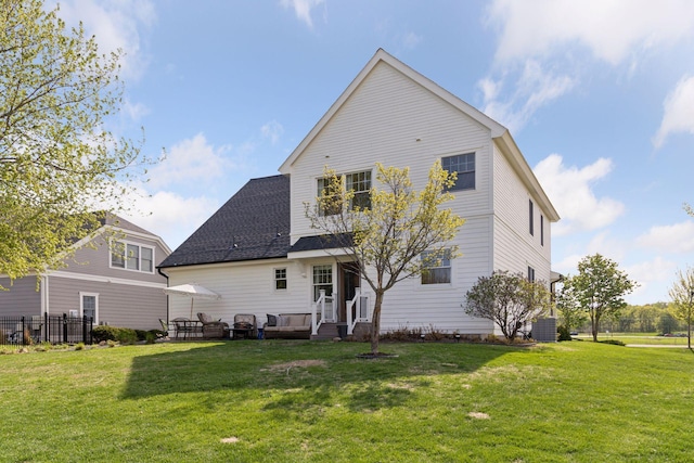 343 Primrose Path, Bayport, MN 55003 - back of property with a lawn and a shingled roof
