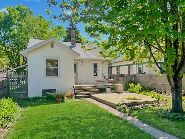 2748 41st Ave S, Minneapolis, MN 55406 - rear view of property with a patio area, a chimney, stucco siding, and a wooden deck