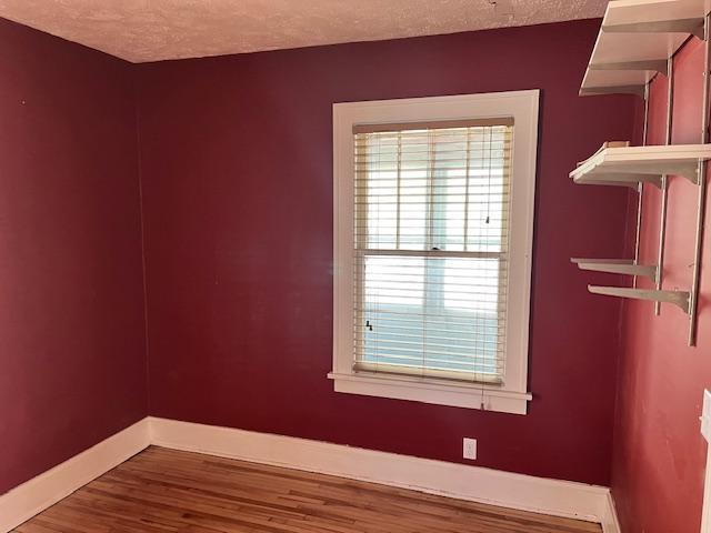 2748 41st Ave S, Minneapolis, MN 55406 - spare room with baseboards, wood finished floors, and a textured ceiling