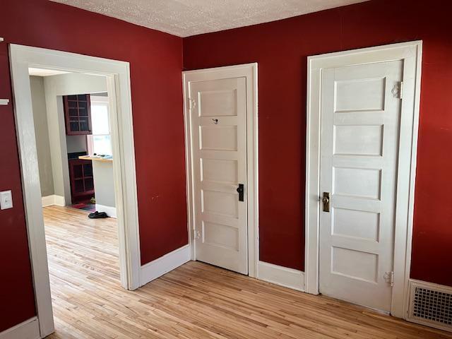 2748 41st Ave S, Minneapolis, MN 55406 - interior space featuring light wood finished floors, baseboards, and a textured ceiling