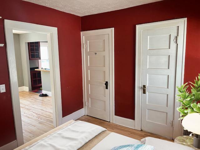 2748 41st Ave S, Minneapolis, MN 55406 - bedroom featuring light wood finished floors, baseboards, and a textured ceiling