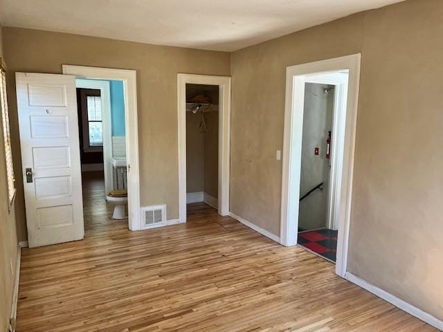 2748 41st Ave S, Minneapolis, MN 55406 - unfurnished bedroom with light wood-type flooring, baseboards, and a closet