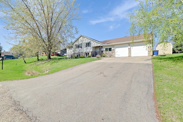 4954 Jeffers Ct, Lonsdale, MN 55046 - view of front of home with stone siding, an attached garage, driveway, and a front yard