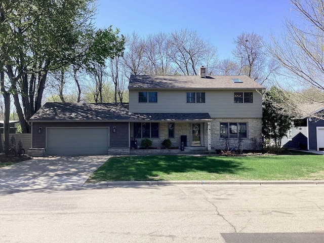 view of front of property with a garage, a front yard, concrete driveway, and a chimney
