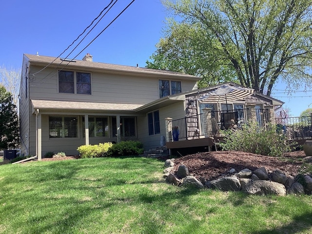 view of front of home with a front yard, a wooden deck, a chimney, and central AC