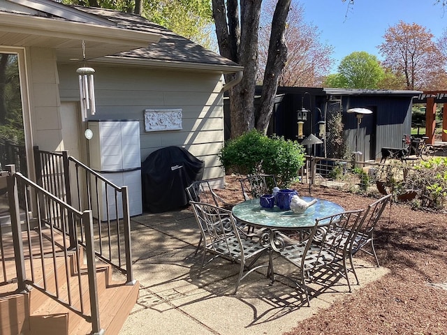 view of patio with outdoor dining area and grilling area
