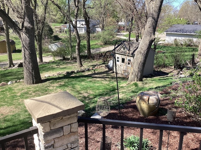 view of yard featuring an outdoor structure and a storage unit