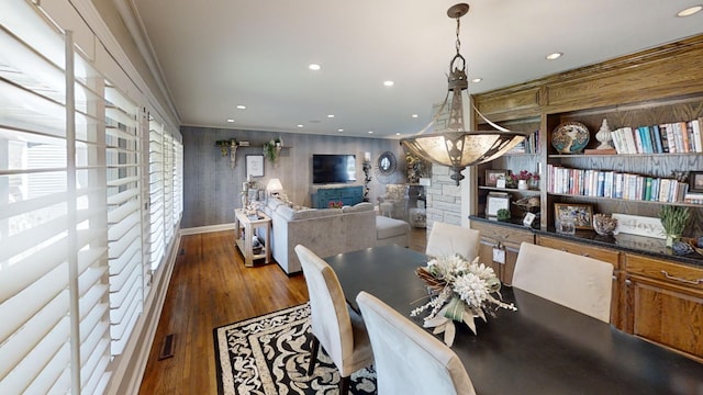 dining area with wood finished floors and recessed lighting