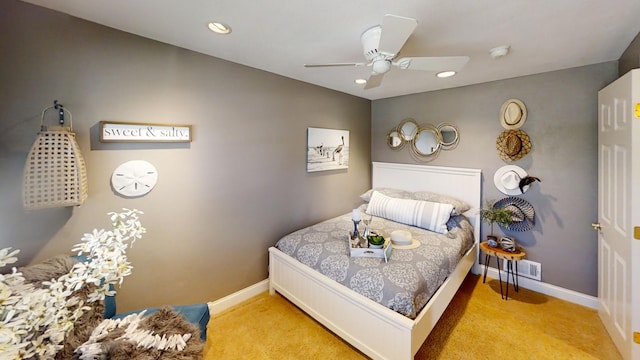 carpeted bedroom featuring baseboards, recessed lighting, and a ceiling fan