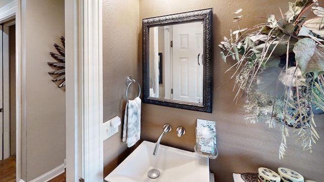 bathroom featuring a sink and wood finished floors