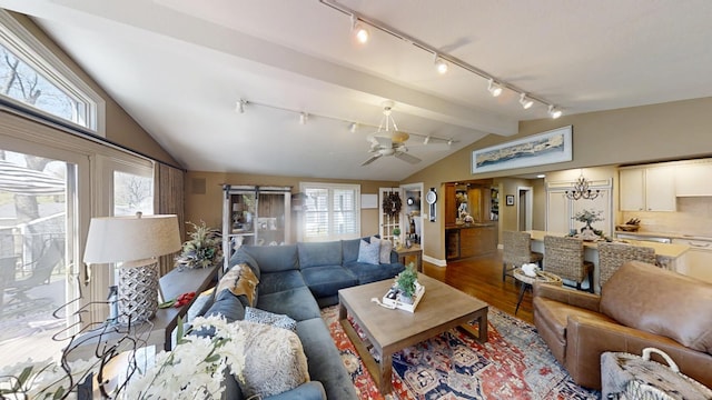 living area with rail lighting, wood finished floors, baseboards, and a ceiling fan