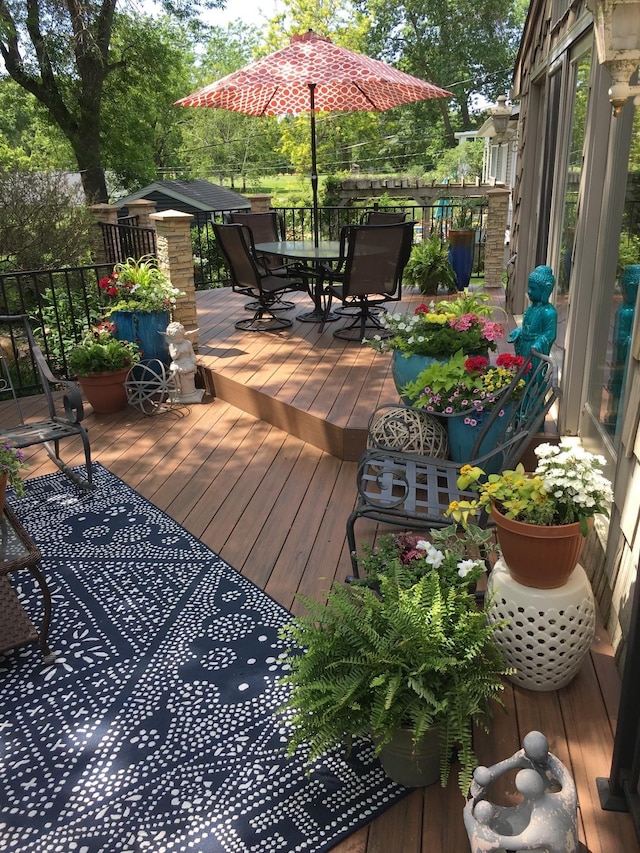 wooden terrace with outdoor dining area