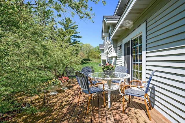 wooden deck featuring outdoor dining space