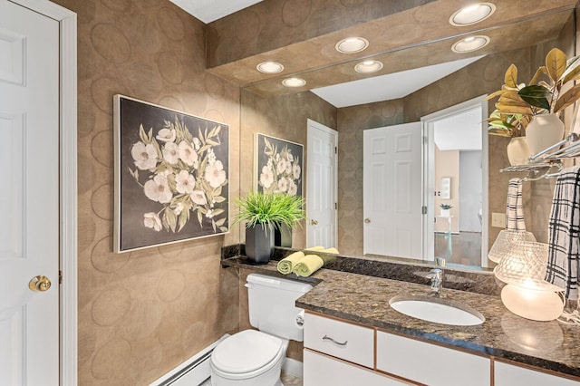 bathroom featuring toilet, vanity, and recessed lighting