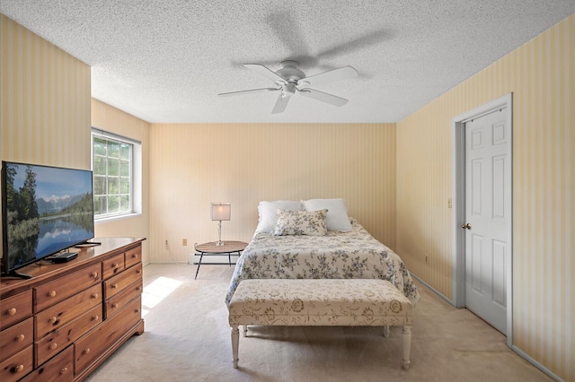 bedroom with light carpet, ceiling fan, a textured ceiling, and a baseboard radiator