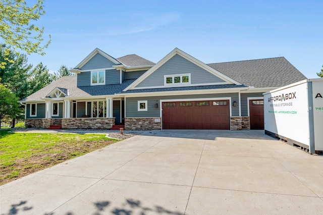 19776 214th Ave NW, Big Lake Twp, MN 55309 - craftsman-style house featuring a porch, concrete driveway, roof with shingles, stone siding, and an attached garage