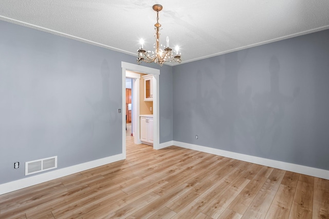 19776 214th Ave NW, Big Lake Twp, MN 55309 - empty room featuring a chandelier, baseboards, and light wood-style flooring