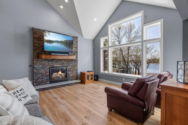 19776 214th Ave NW, Big Lake Twp, MN 55309 - living area with high vaulted ceiling, a fireplace, light wood-type flooring, baseboards, and recessed lighting