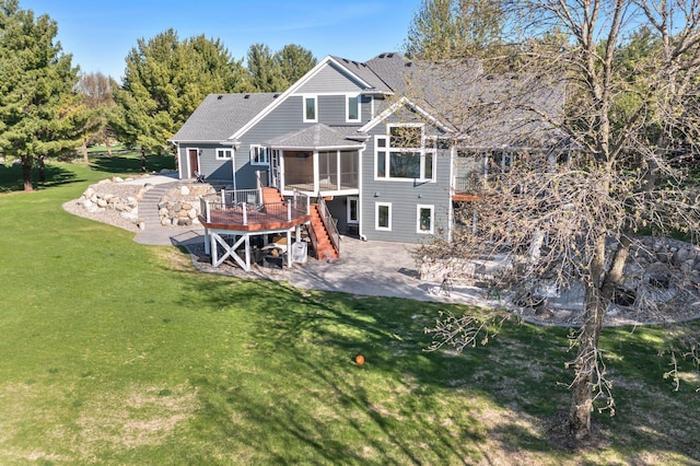 19776 214th Ave NW, Big Lake Twp, MN 55309 - rear view of house featuring a patio, a wooden deck, stairs, a lawn, and a shingled roof