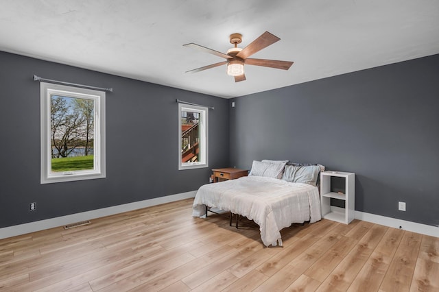 19776 214th Ave NW, Big Lake Twp, MN 55309 - bedroom with baseboards, light wood-type flooring, and ceiling fan