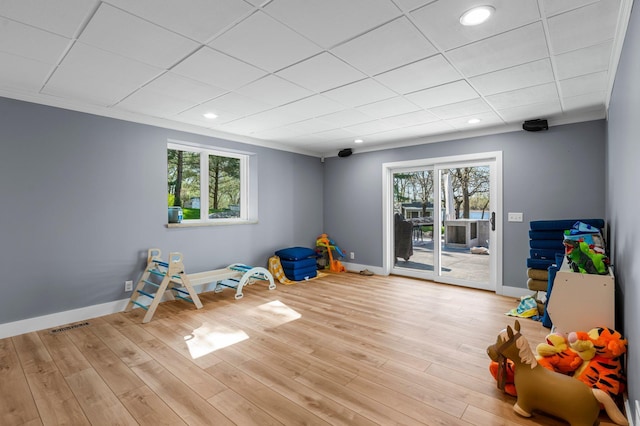 19776 214th Ave NW, Big Lake Twp, MN 55309 - recreation room featuring baseboards, recessed lighting, wood finished floors, a drop ceiling, and ornamental molding