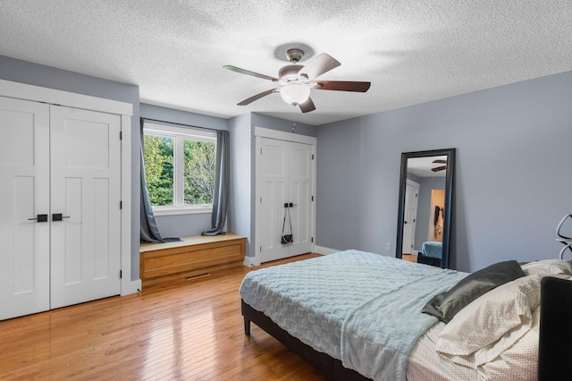 19776 214th Ave NW, Big Lake Twp, MN 55309 - bedroom featuring light wood-style flooring, multiple closets, a textured ceiling, and a ceiling fan
