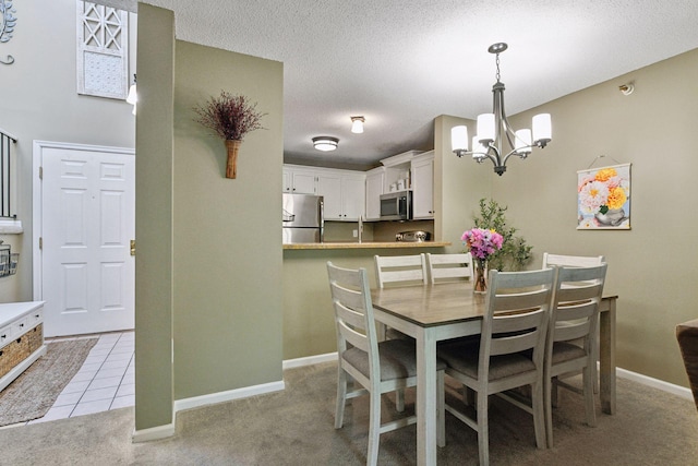 7618 York Ave S Unit 1318, Edina, MN 55435 - dining area with a chandelier, light colored carpet, baseboards, and a textured ceiling