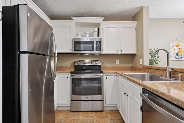 7618 York Ave S Unit 1318, Edina, MN 55435 - kitchen featuring stainless steel appliances, a sink, white cabinetry, light countertops, and a textured ceiling