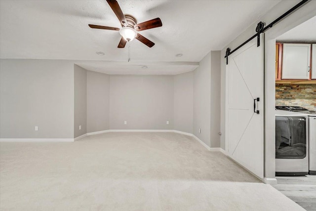 14716 Oak Run Ln, Burnsville, MN 55306 - unfurnished living room with a barn door, separate washer and dryer, ceiling fan, and light colored carpet