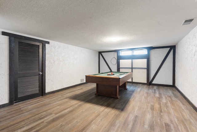 playroom featuring a textured wall, a textured ceiling, wood finished floors, billiards table, and baseboards