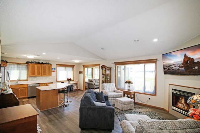 4129 6th St S, Saint Cloud, MN 56301 - living area with lofted ceiling, dark wood-style floors, plenty of natural light, a glass covered fireplace, and recessed lighting