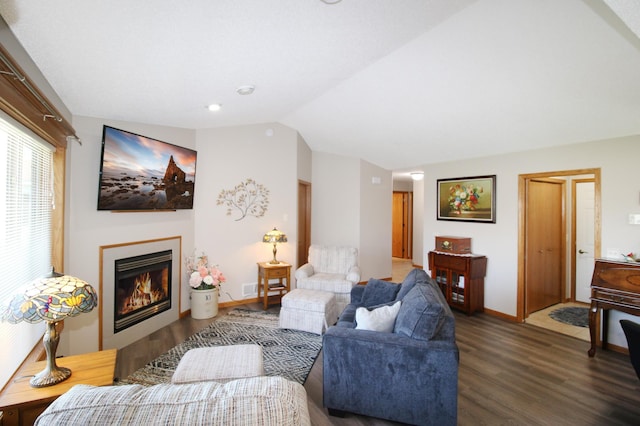 4129 6th St S, Saint Cloud, MN 56301 - living area with wood finished floors, vaulted ceiling, a glass covered fireplace, and baseboards