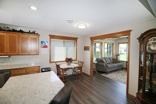 4129 6th St S, Saint Cloud, MN 56301 - kitchen with dark wood-type flooring, baseboards, dishwashing machine, and brown cabinets