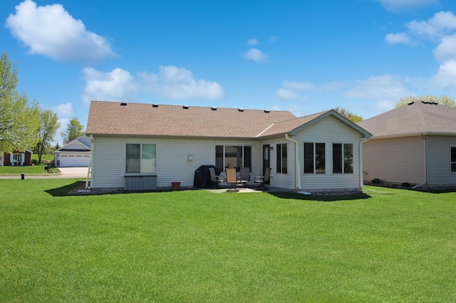4129 6th St S, Saint Cloud, MN 56301 - rear view of house with a yard, a patio, roof with shingles, and a detached garage