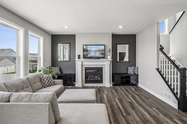 104 Hummingbird Way, Delano, MN 55328 - living area featuring dark wood finished floors, stairway, recessed lighting, a textured ceiling, and a tile fireplace