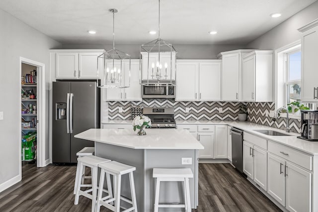 104 Hummingbird Way, Delano, MN 55328 - kitchen featuring stainless steel appliances, a sink, dark wood finished floors, white cabinetry, and recessed lighting