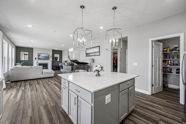 104 Hummingbird Way, Delano, MN 55328 - kitchen with dark wood-style flooring, a center island, light countertops, gray cabinets, and pendant lighting