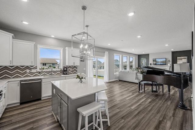 104 Hummingbird Way, Delano, MN 55328 - kitchen with dishwasher, open floor plan, dark wood-style floors, white cabinetry, and recessed lighting