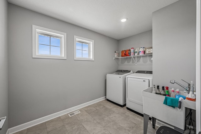 104 Hummingbird Way, Delano, MN 55328 - washroom featuring washer and dryer and a textured ceiling