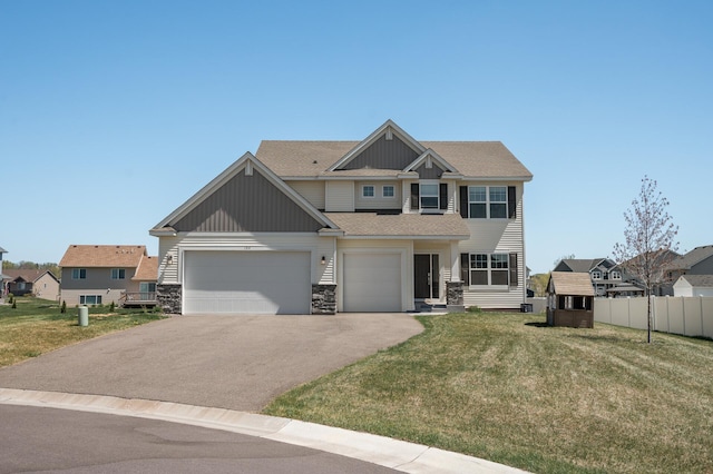 104 Hummingbird Way, Delano, MN 55328 - view of front facade featuring driveway, stone siding, a garage, board and batten siding, and a shingled roof