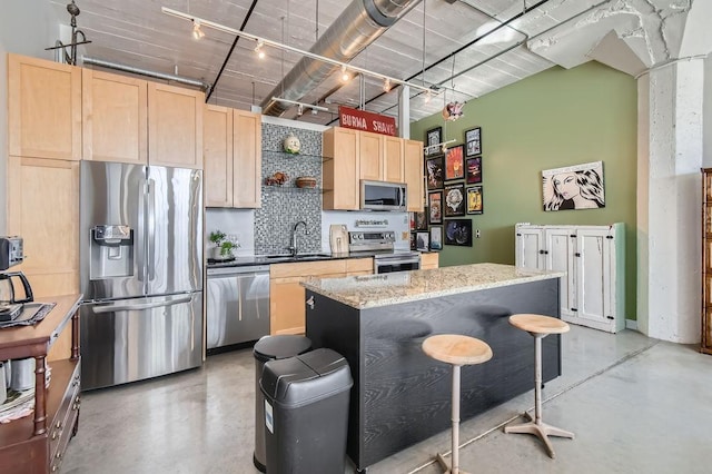 730 Stinson Blvd Unit 205, Minneapolis, MN 55413 - kitchen featuring appliances with stainless steel finishes, light brown cabinetry, concrete floors, tasteful backsplash, and open shelves