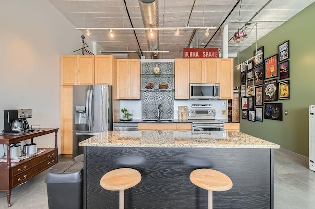 730 Stinson Blvd Unit 205, Minneapolis, MN 55413 - kitchen with stainless steel appliances, rail lighting, light brown cabinetry, a sink, and concrete floors