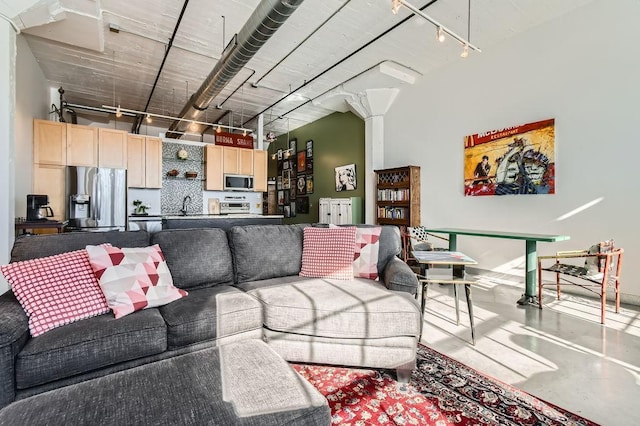 730 Stinson Blvd Unit 205, Minneapolis, MN 55413 - living area with rail lighting and finished concrete floors
